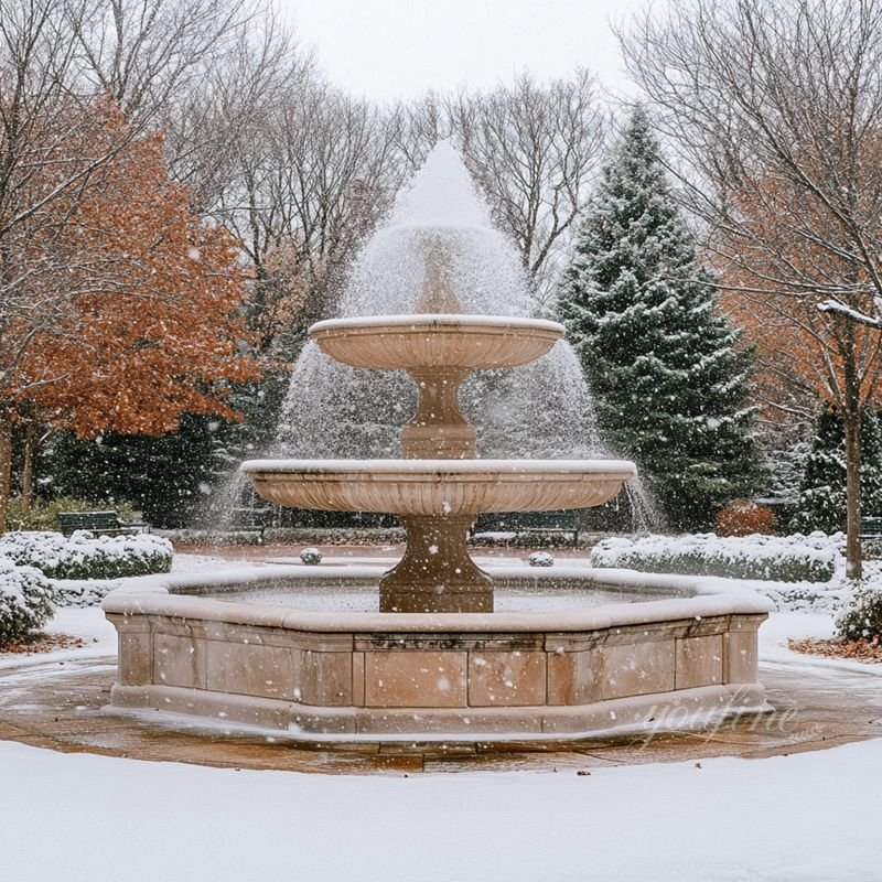 beige marble fountain outdoors in winter