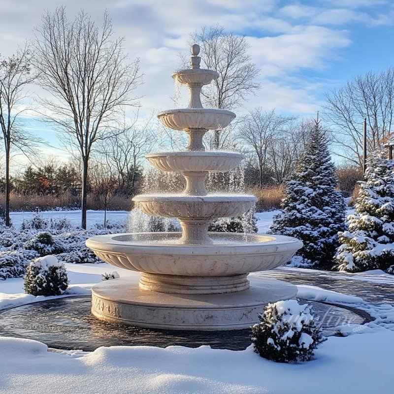 tiered marble fountain outdoors in winter