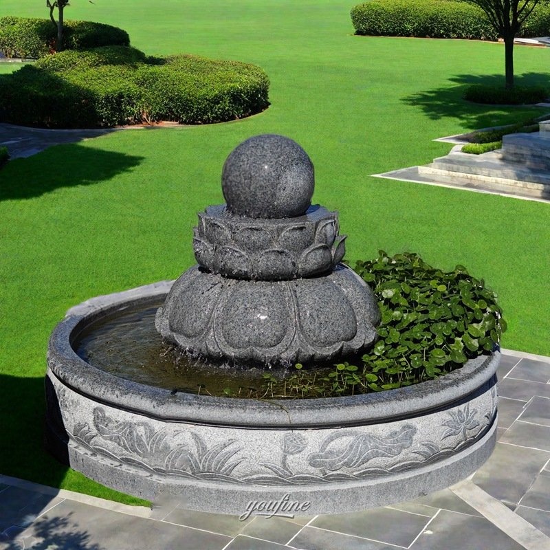 gray stone ball on lotus seat fountain