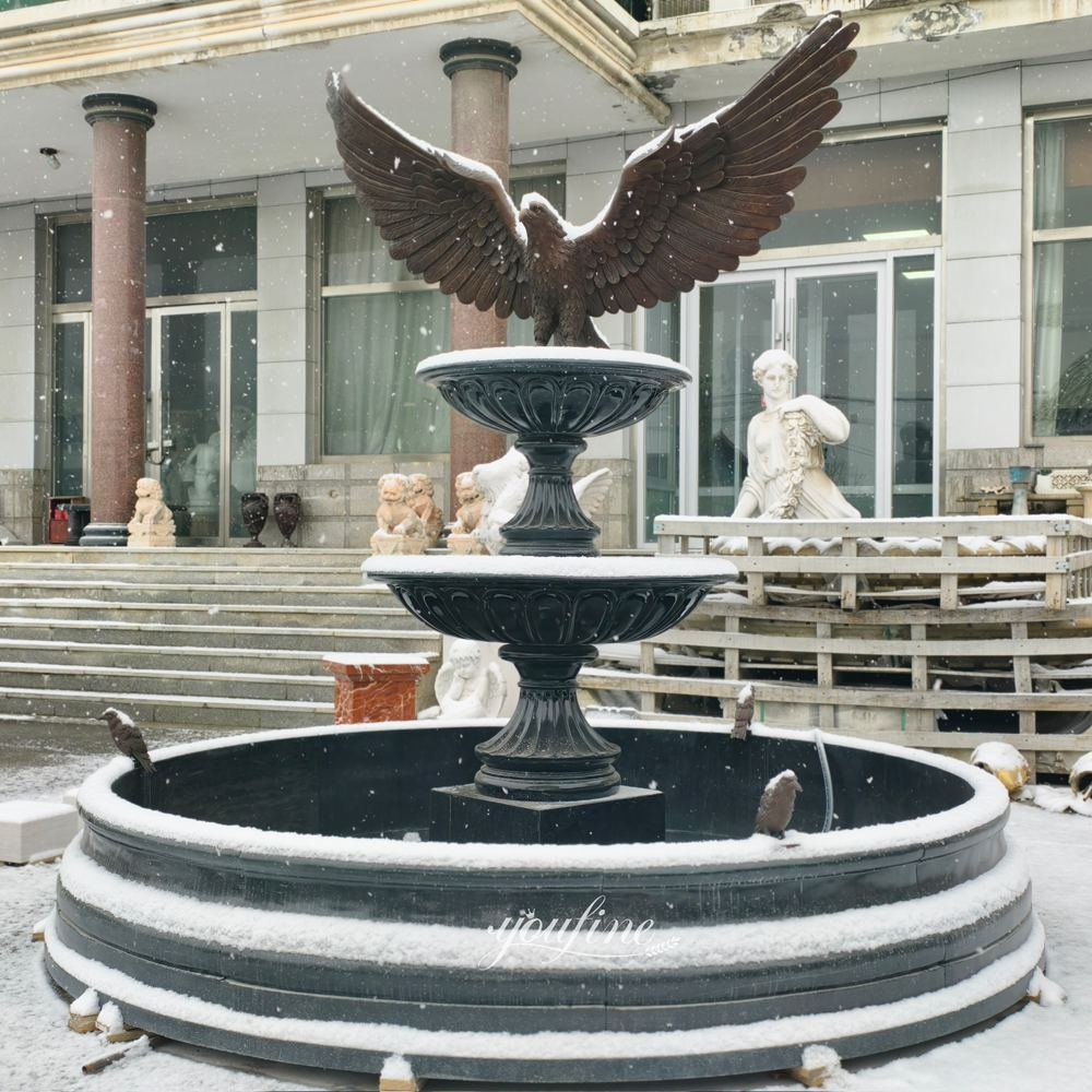 marble water fountain with bronze eagle statue