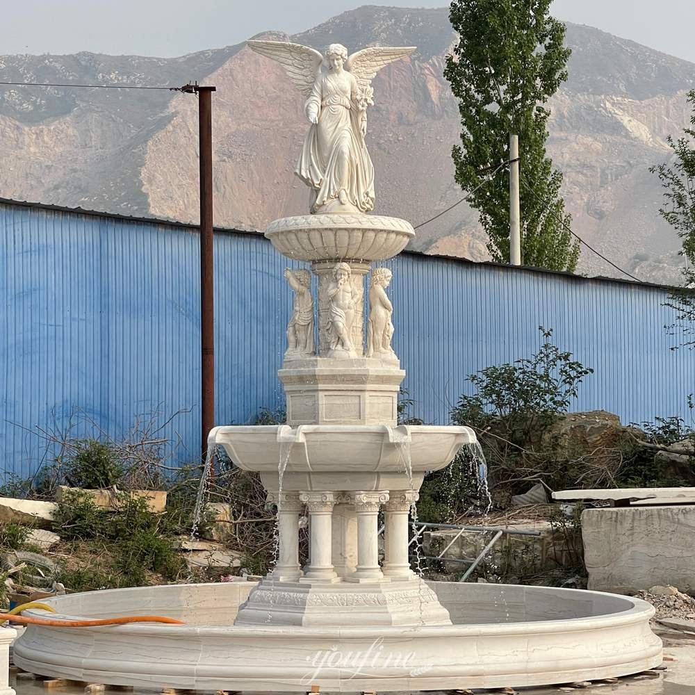 carved fountain with walking angel lily & cherub statues with water flow