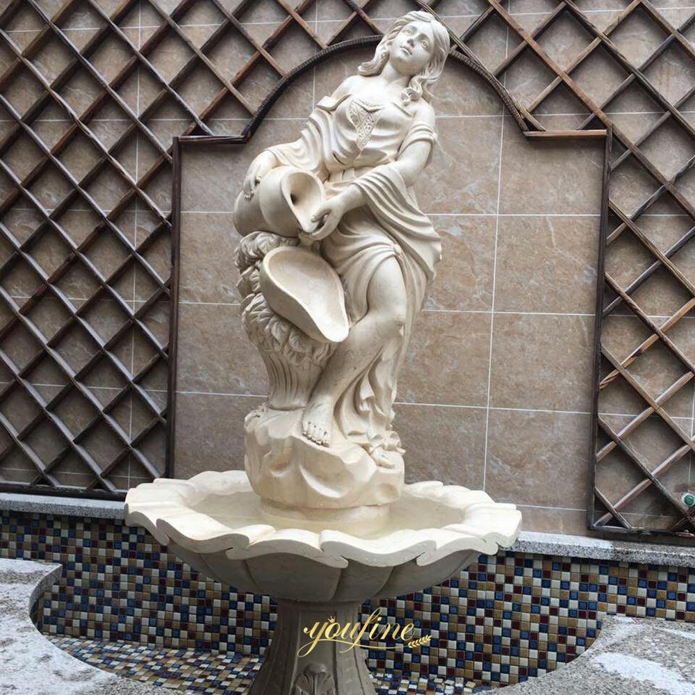 a beige woman holding a water jar marble fountain