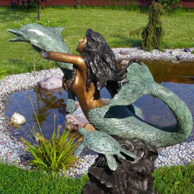 bronze mermaid holding a dolphin fountain