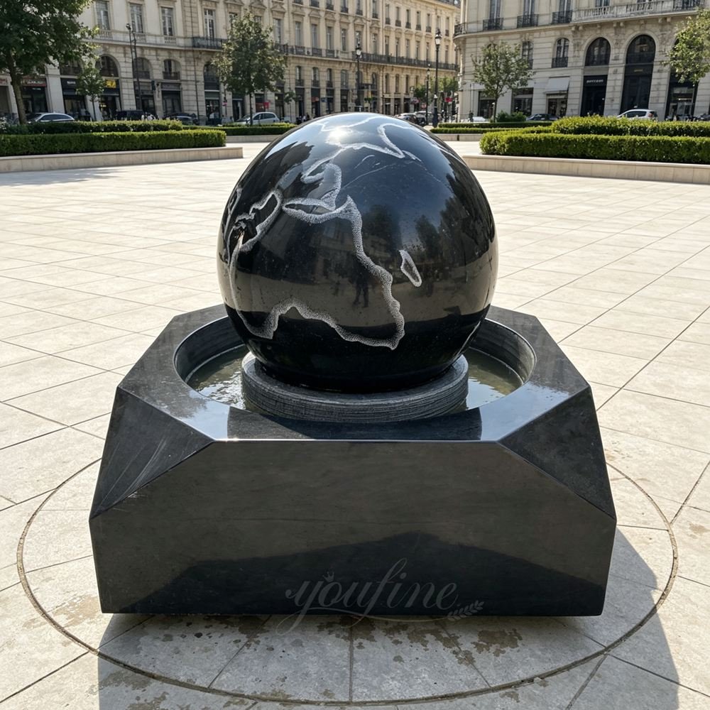 black marble ball fountain with carved world map