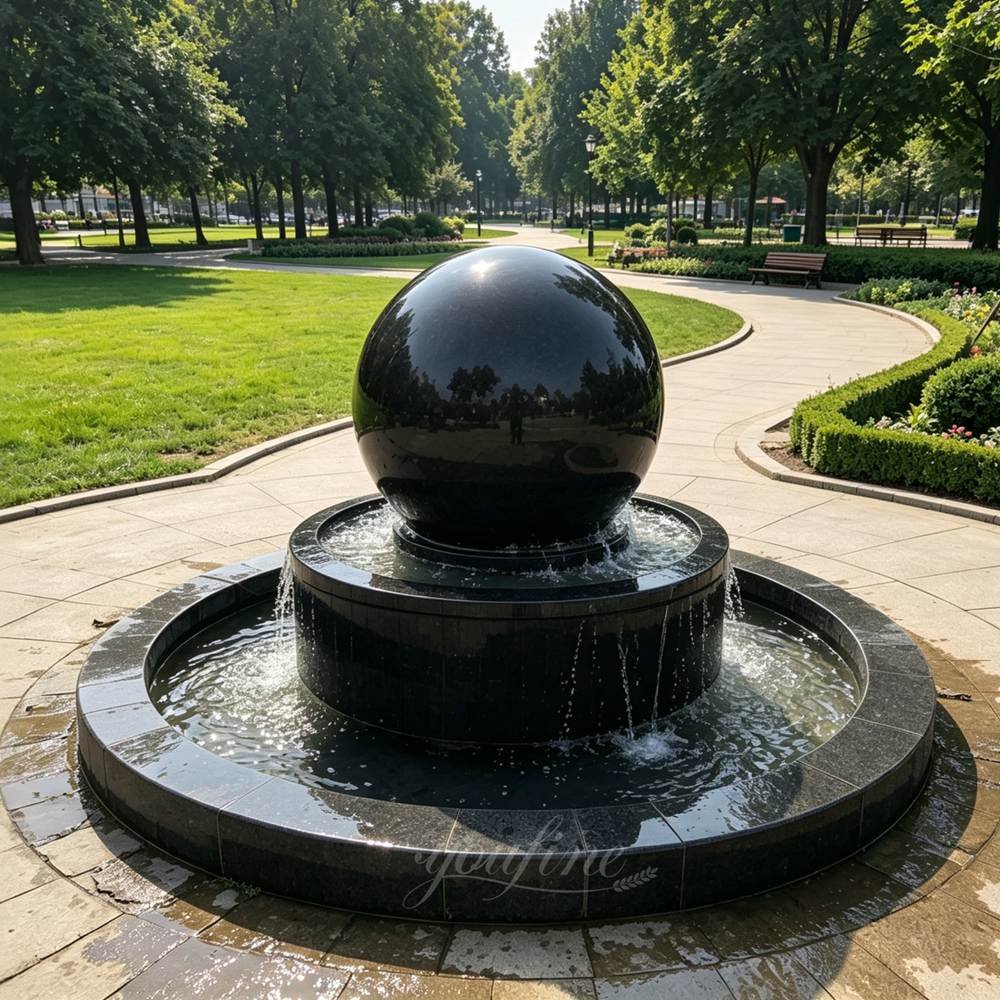 two-tier black marble sphere fountain on a veined marble base