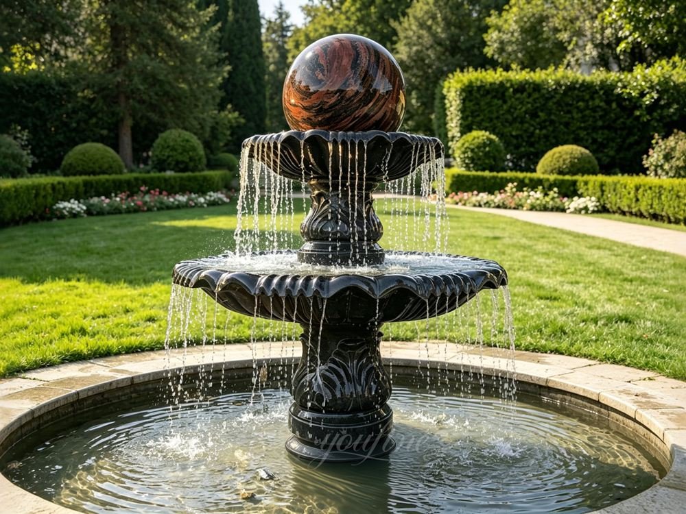 marble sphere fountain with polished rotating ball in a garden courtyard